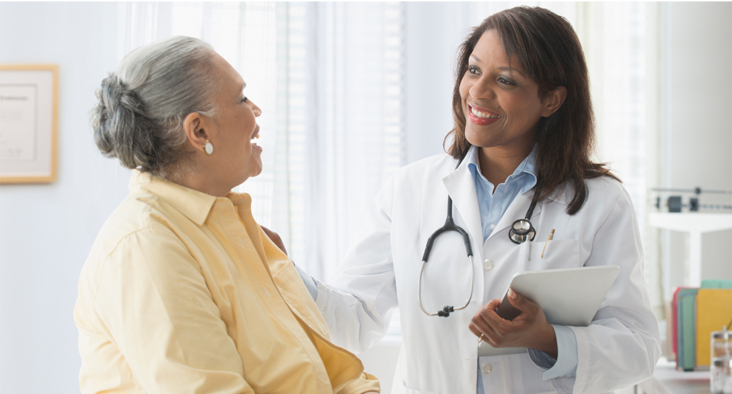 Medicare Part B at work, as a female patient and doctor discuss preventive healthcare